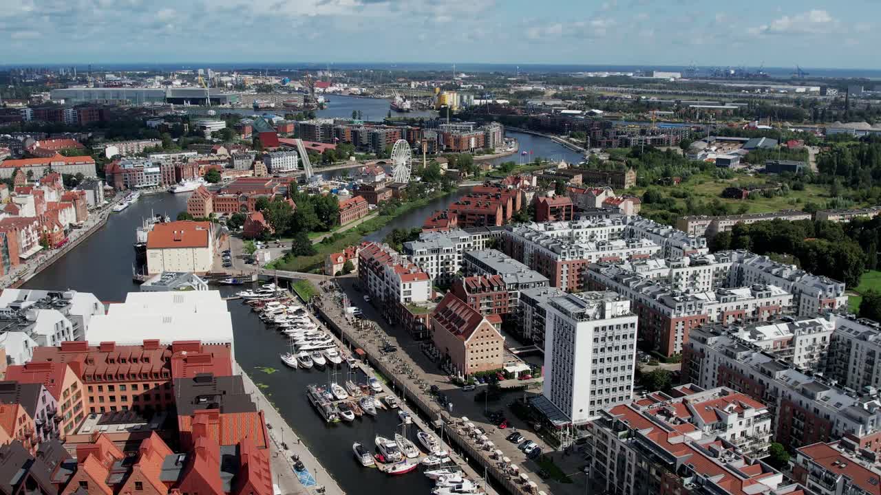 Drone shot over Gdansk marina along the Motlawa River with red brick buildings