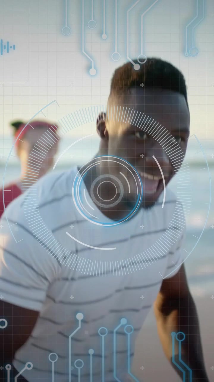 Vertical video: Man stepping forward, dancing on beach while HUD tracking chest for social media