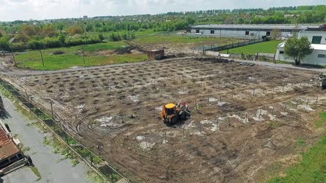 aerial view of construction. yellow excavator working on construction site