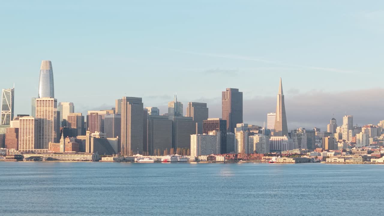 Morning fog lifts as the skyline emerges, revealing the full stretch of San Francisco’s eastern architectural spine.