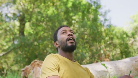 happy african american man relaxing and admiring nature in park, slow motion