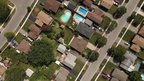 aerial birds eye shot of suburban neighborhood in welland with road and cars during sunny day - canada,ontario