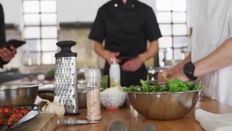 caucasian female chef teaching diverse group