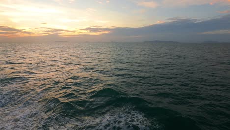 colorful sunset sky with golden yellow cloud over sea water wave