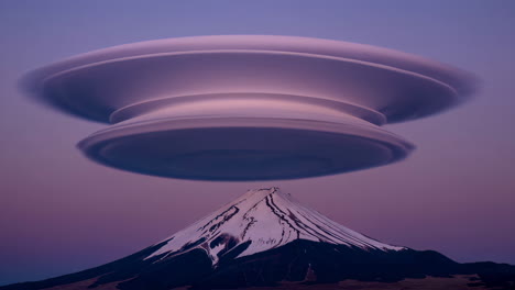lenticular cloud over a snow-capped mountain at twilight
