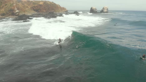 girl paddling and catching wave on a sunny day at punta de lobos, pichilemu-4k