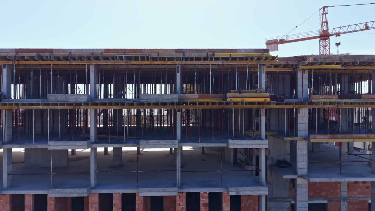 Construction site shows building framework in process at new development location on a clear day with blue sky