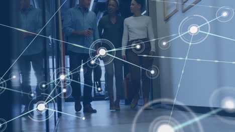 animation of network of connections over diverse team of colleagues discussing together at office