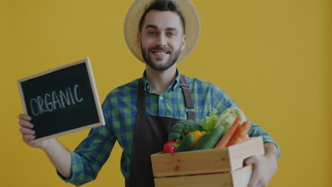 friendly farmer holding a crate of organic vegetables