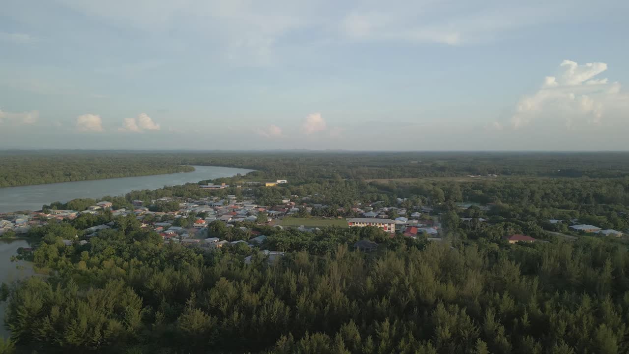Aerial Drone View During Summer Gerigat Fishing Village,Kabong With, Facing Open Blue Sea, White Sandy Beach,Green Coconut, Palm Trees,And River,Sarawak,Borneo