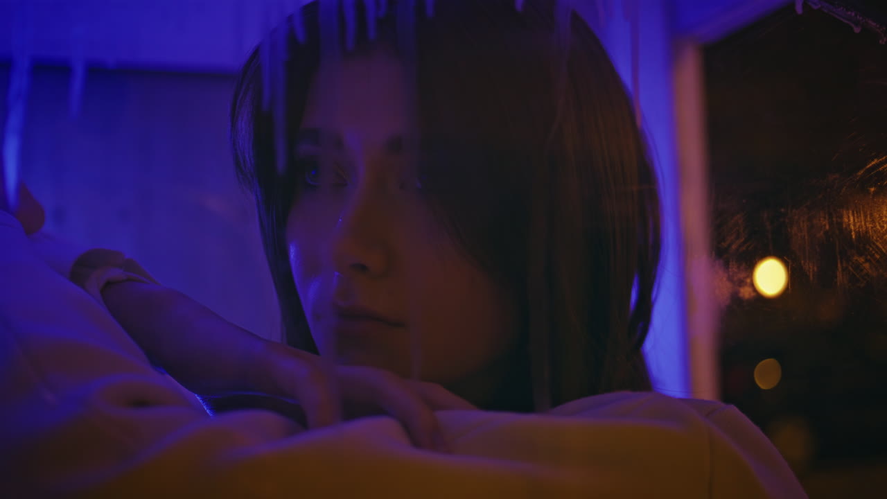 Closeup model posing neon lights at night. Attractive sad girl looking camera