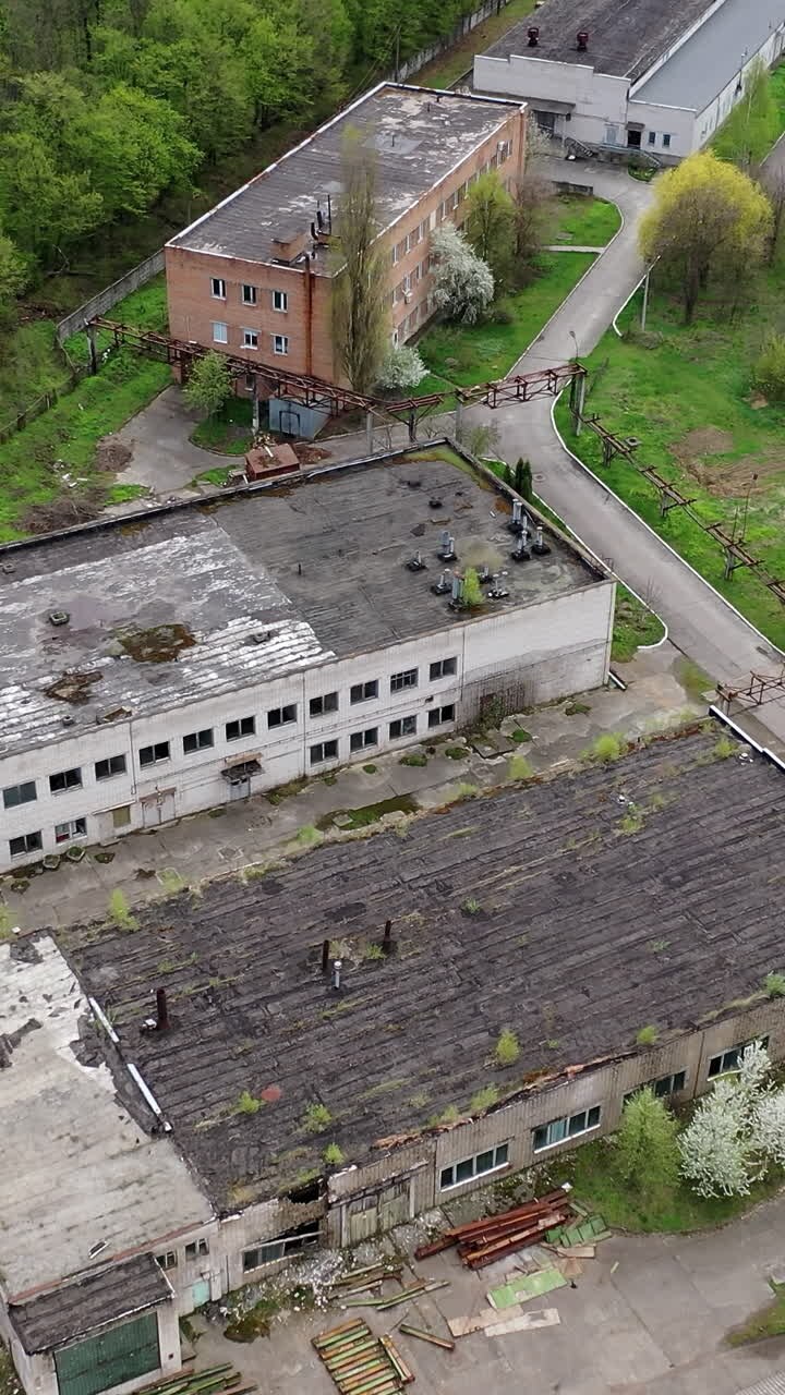 Apocalypsis aero view city. Aerial shot of crashed ruined factory in the city. Vertical video
