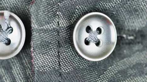 silver metallic buttons fasten in a damask fabric