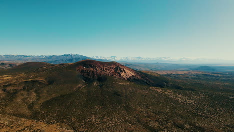 panoramic image of volcan malacara in malargüe, with the imposing andes mountain range in the background