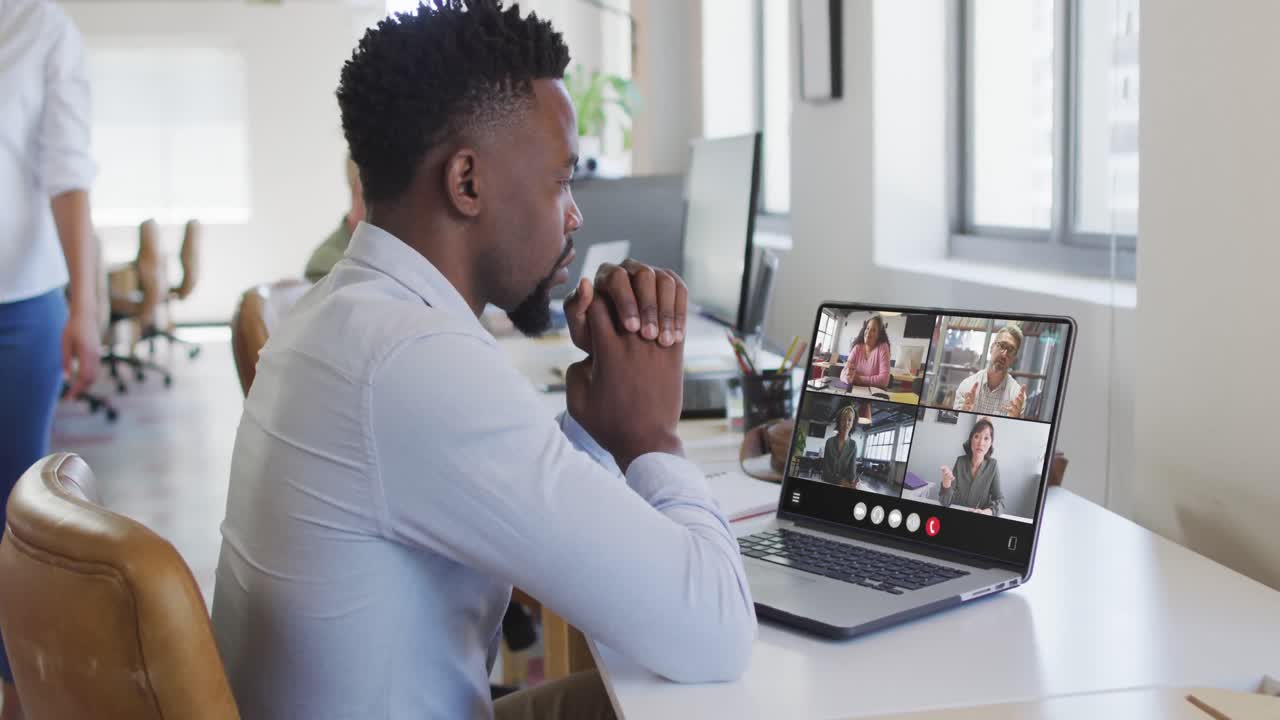 Animation of african american man having video call on laptop