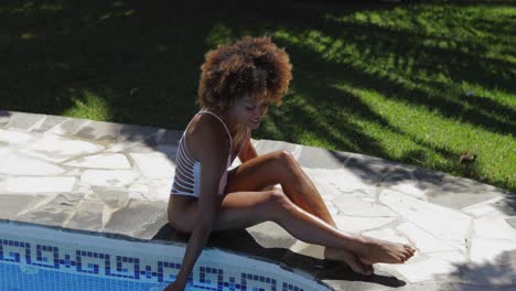 charming girl posing on poolside
