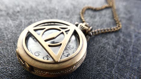 vintage gold pocket watch with harry potter symbol