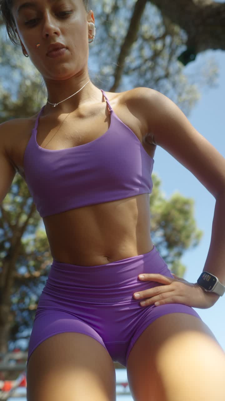 Woman in purple athletic wear ready for a workout