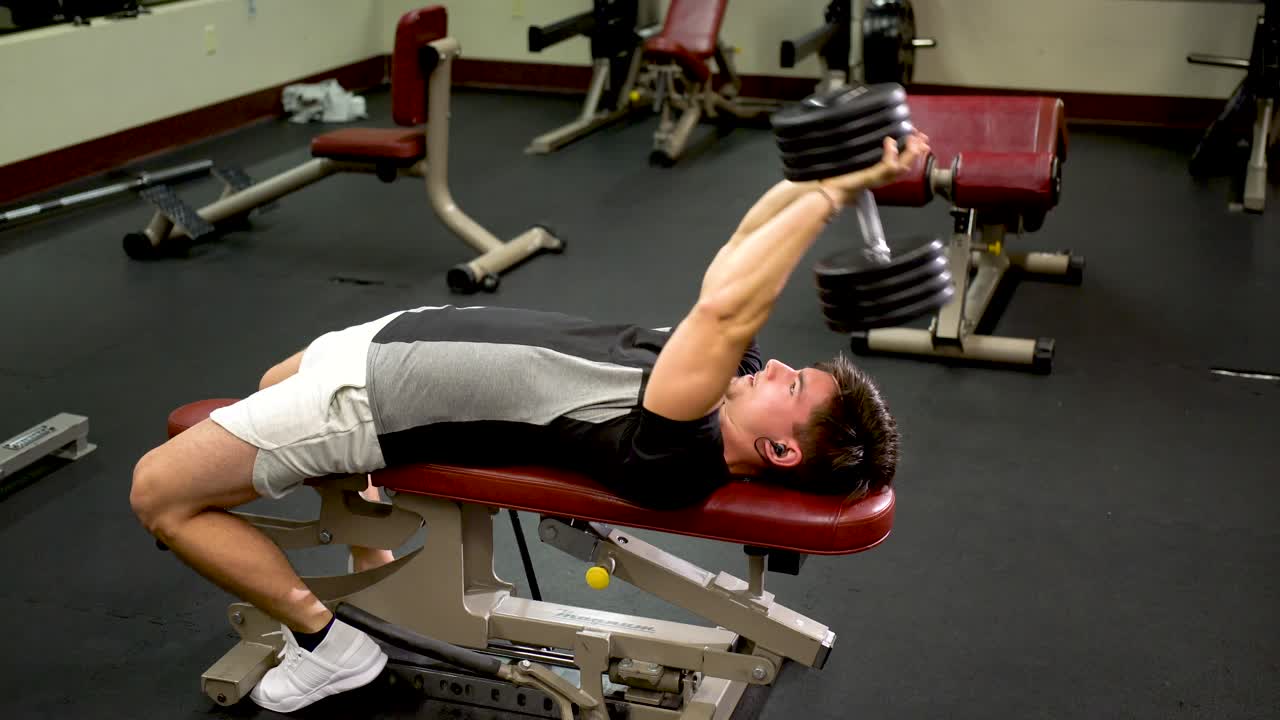 Man lifting dumbbell in gym