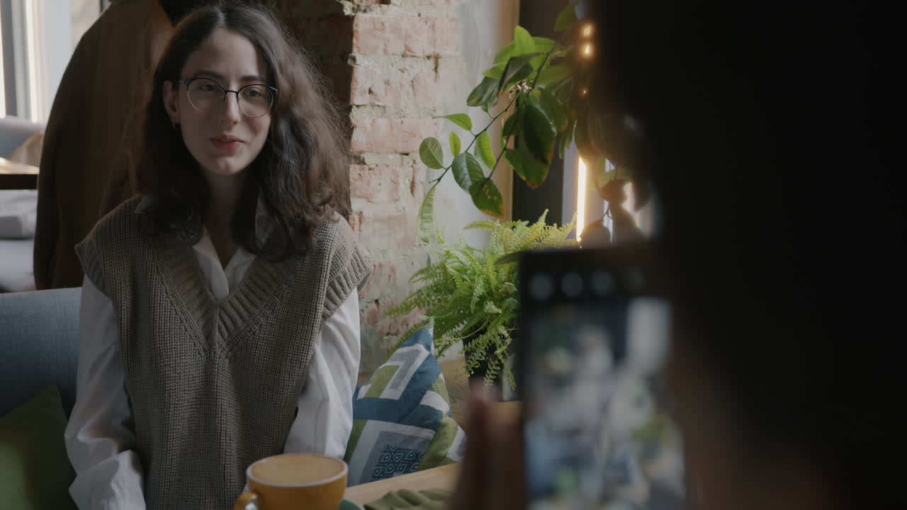 Woman having a video call in a cafe