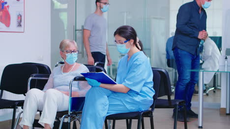 disabled senior woman talking with nurse