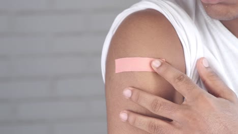 person with a bandage on their arm after vaccination