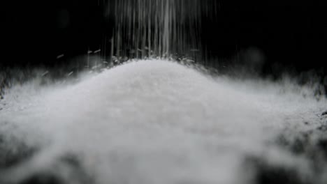 sugar falling on black background 4k