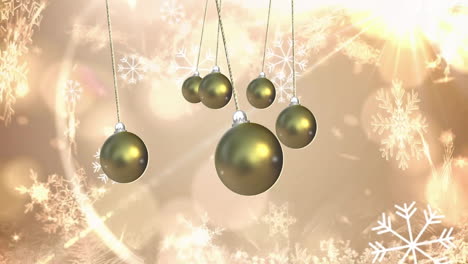 Hanging golden Christmas ornaments over snowflakes animation on light background