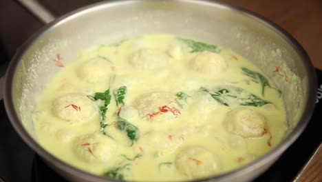 creamy saffron sauce with meatballs and spinach