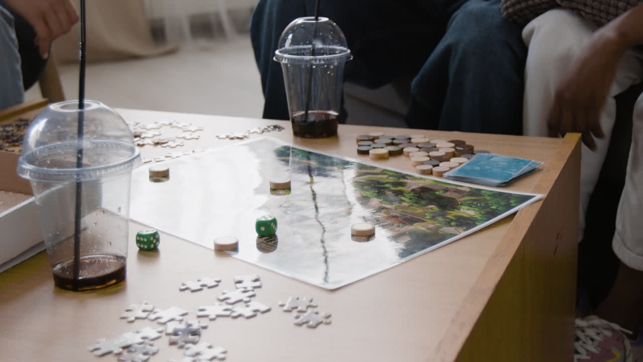 Friends playing board games and puzzles at home