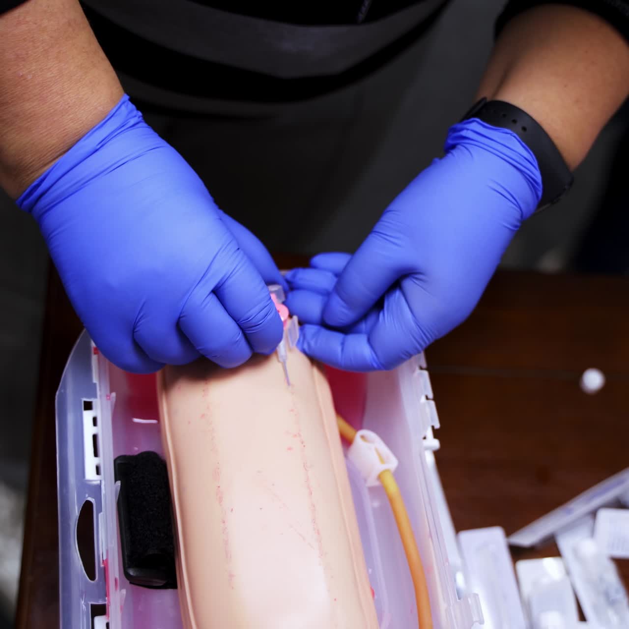 Practical procedure with an injection. Student practices to prick injection into dummy's hand in the training center. Top view. Close-up