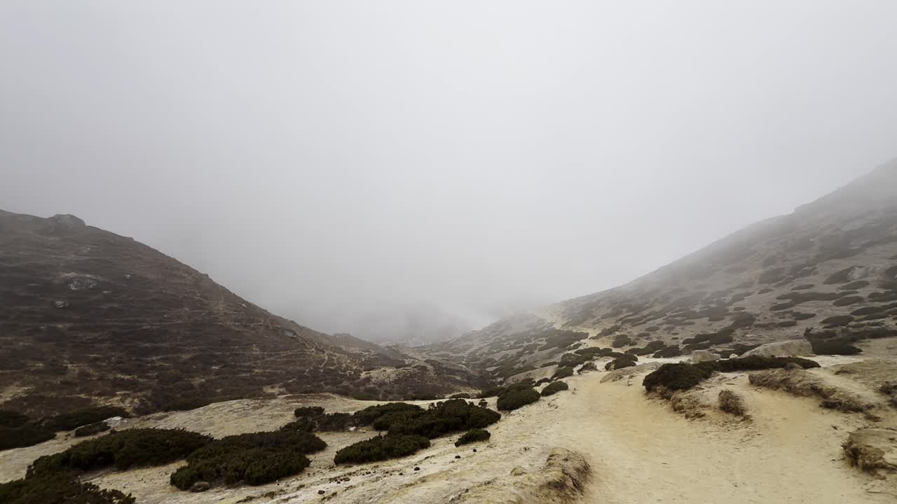 A desolate, fog-covered mountain peak above 4000 meters reveals a hauntingly beautiful and isolated world.