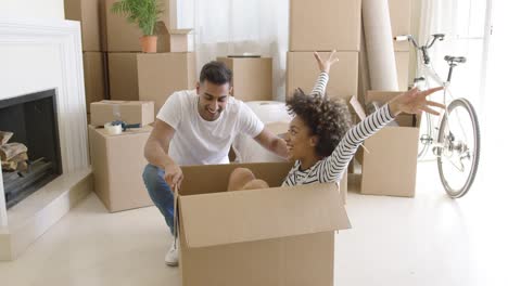 happy mixed race couple having fun break with unpacking