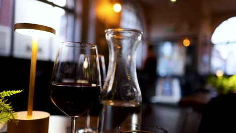 wine glasses and carafe on a restaurant table