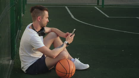 man relaxing on a basketball court