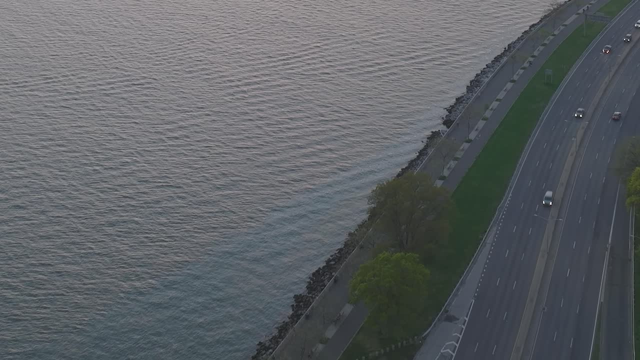 Aerial view of water, coastline, and road with traffic