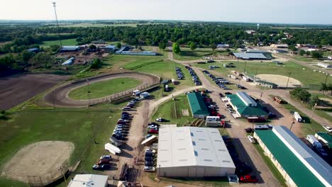 empuje aéreo en los terrenos del centro ecuestre, incluidos caminos de tierra, estructuras metálicas, automóviles, camiones y remolques, kansas, concepto de missouri: rural, ecuestre, medio oeste