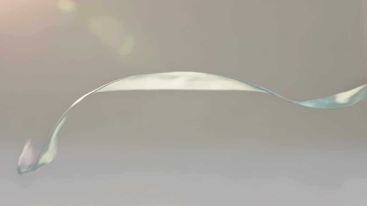 Floating iridescent ribbon streamer moving across studio backdrop, offscreen fan creating motion