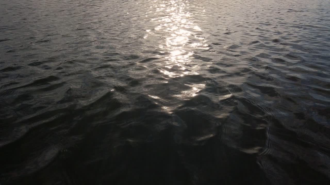 Sunrise sun reflections on the flowing river water in the morning