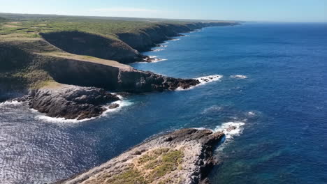 rugged cliffs and blue ocean coastline