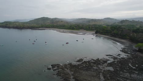 Aerial-view-of-the-beautiful-Santa-Catalina-coastline-in-Panama,-showcasing-scenic-landscapes,-serene-waters,-and-scattered-boats