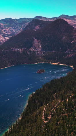 tremendous view of beautiful lake tahoe surrounded by sierra nevada mountains. stunning wildlife panorama at the backdrop of blue sky. vertical video