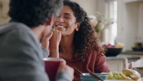 Hermosa-Mujer-Feliz-Charlando-Con-Su-Marido-En-Casa-Disfrutando-De-Una-Conversación-Cogidos-De-La-Mano-En-La-Cocina-Durante-El-Desayuno