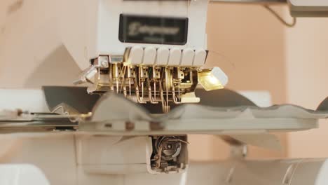 the automatic embroidery machine is working at high speed. close-up