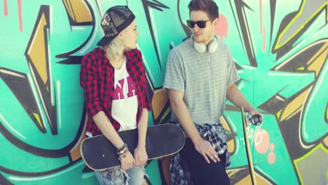 trendy young skateboarders standing chatting