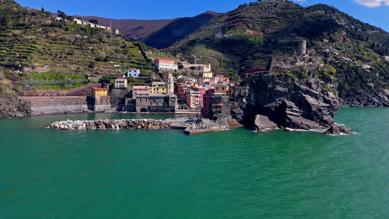 Vibrant coastal village of Vernazza in Cinque Terre, Italy, surrounded by clear turquoise waters