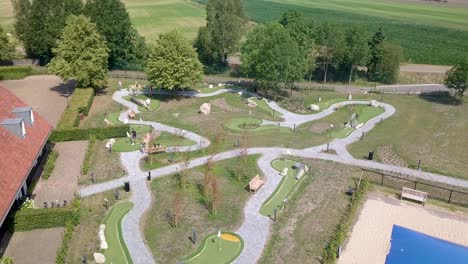 close-up aerial view of people playing miniature golf