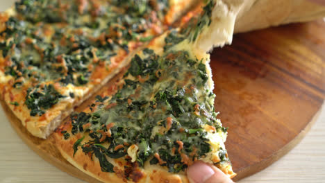 spinach and cheese pizza on wood tray - vegan and vegetarian food style