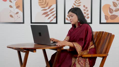 tired indian woman working on laptop