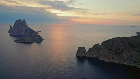 sunset scenery at es vedrà island in ibiza, spain - aerial drone shot